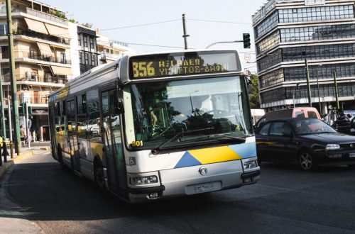 Cityscape of Athens featuring a public bus on a bustling street, capturing urban life.