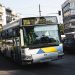 Cityscape of Athens featuring a public bus on a bustling street, capturing urban life.